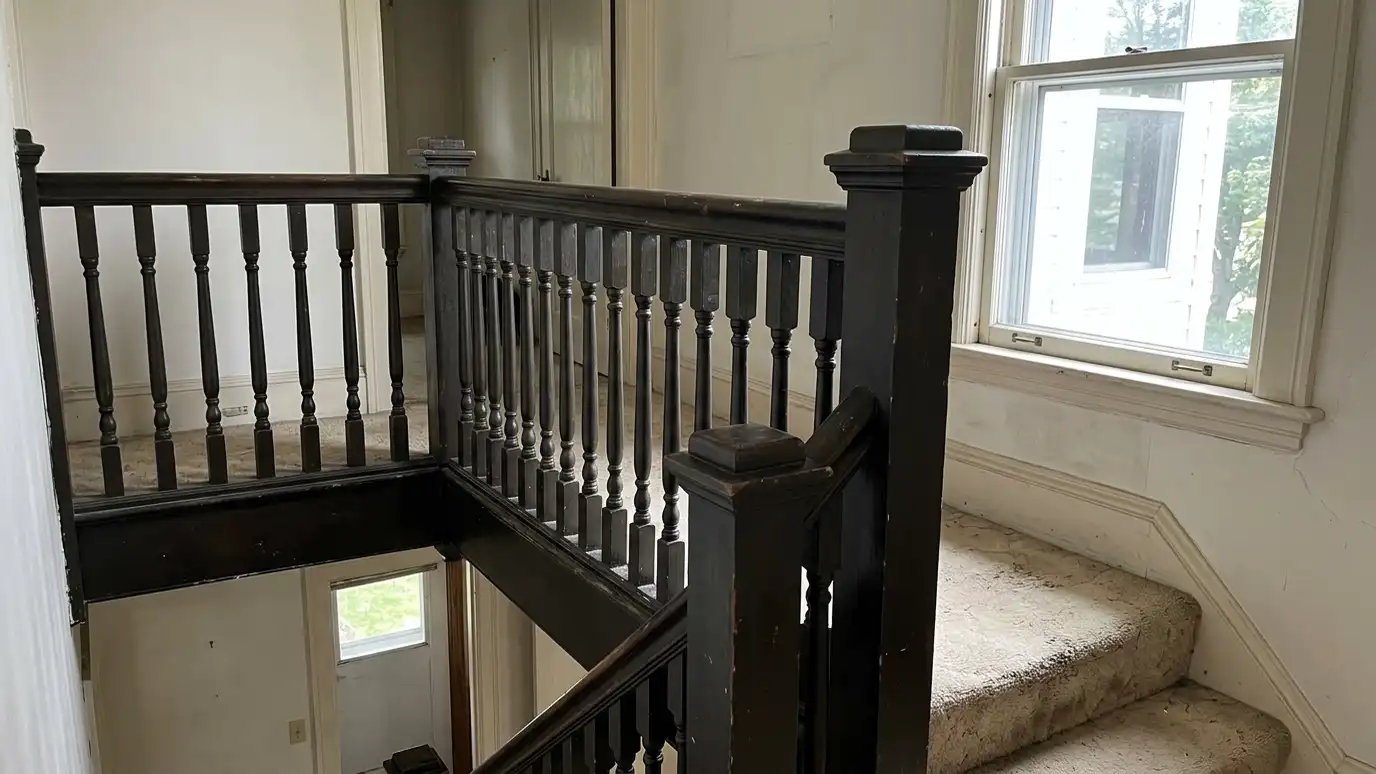 Before: a stair landing with a dark painted wood balustrade with thick posts